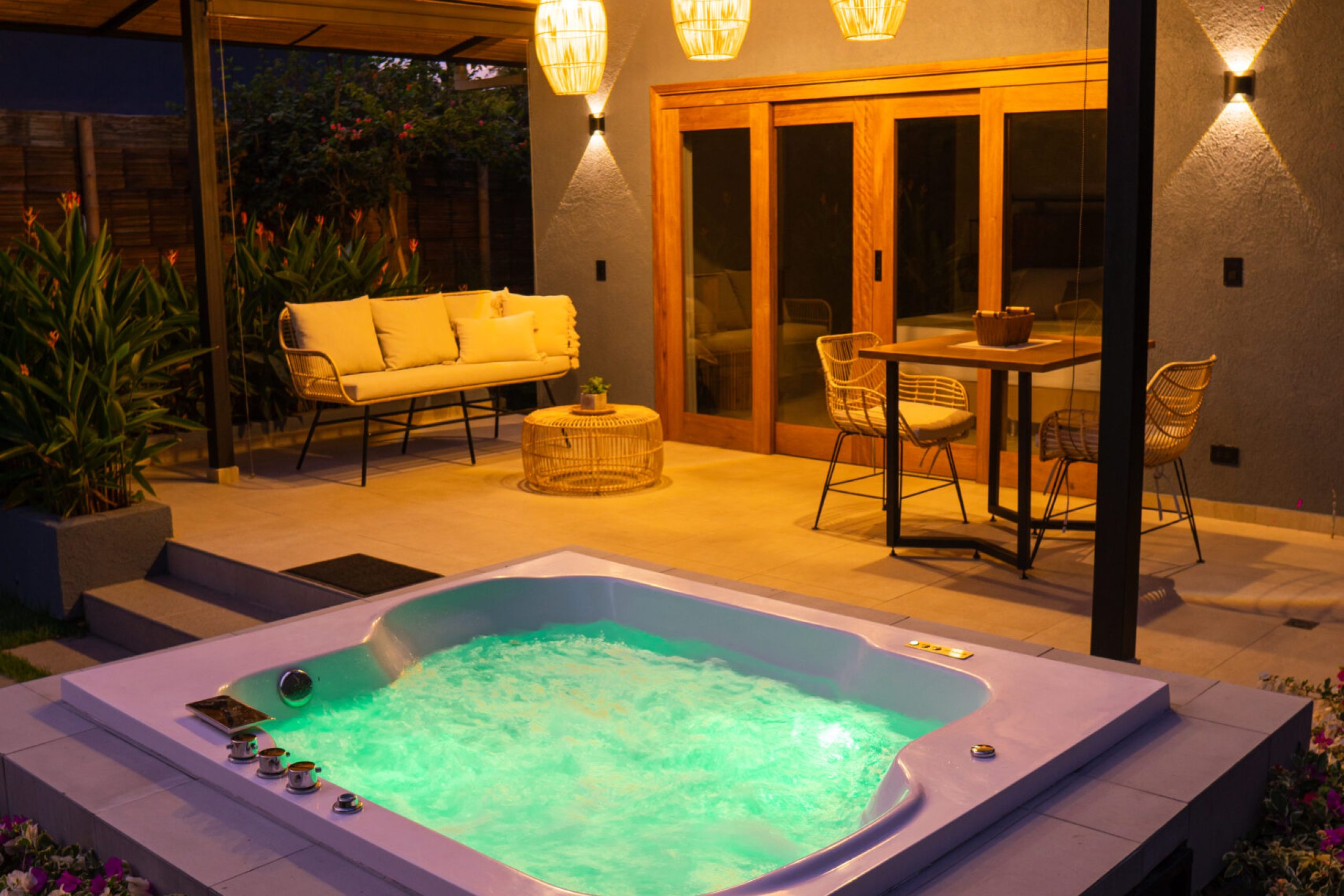 foto exterior de la cabaña carpintero real jacuzzi atardecer lamparas y mesa de la terraza